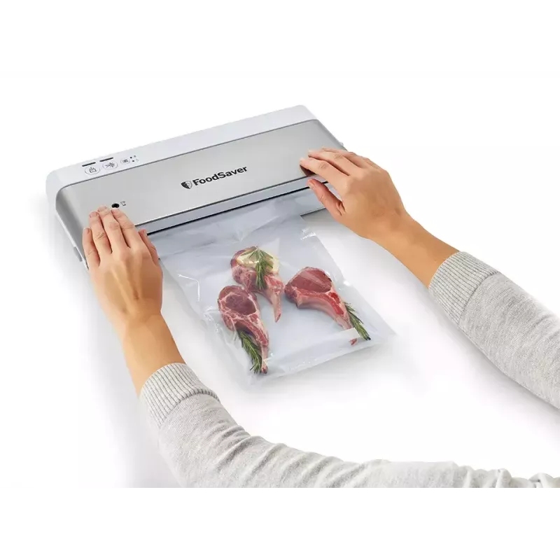 Envasadora al vacío FoodSaver VS0100X — dial giratorio, incluye rollo de film y 4 bolsas de vacío, blanco plateado