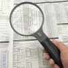 Lupa Carson Split Handle HF-11 — lupa de mano 3,5×, negro/transparente, pila AAA